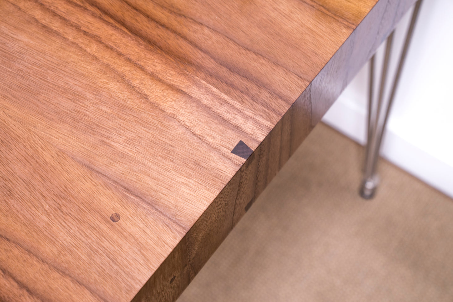 close up of dovetail miter edge and wood details on contemporary walnut desk 