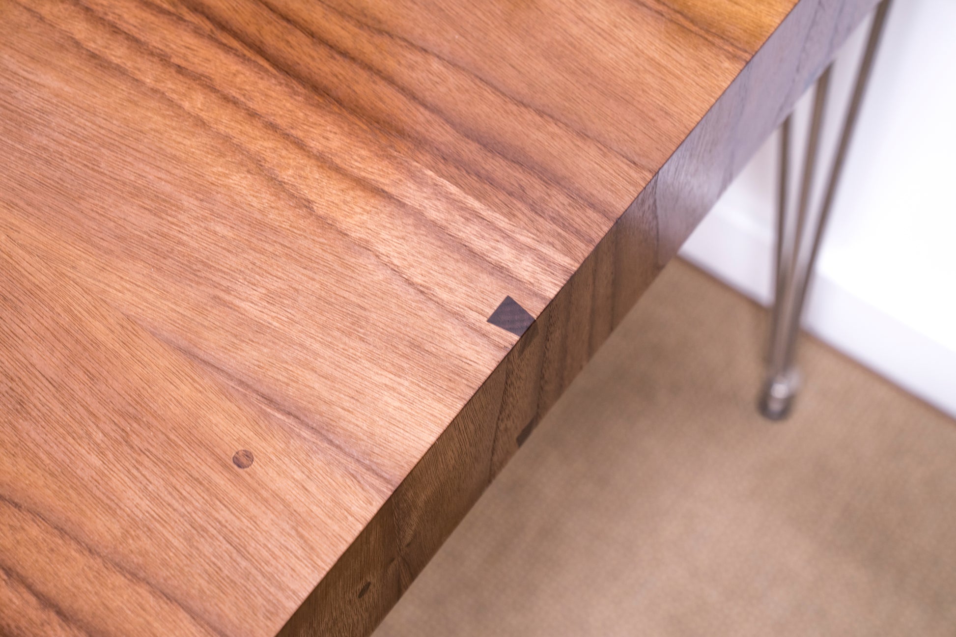 close up of dovetail miter edge and wood details on contemporary walnut desk 