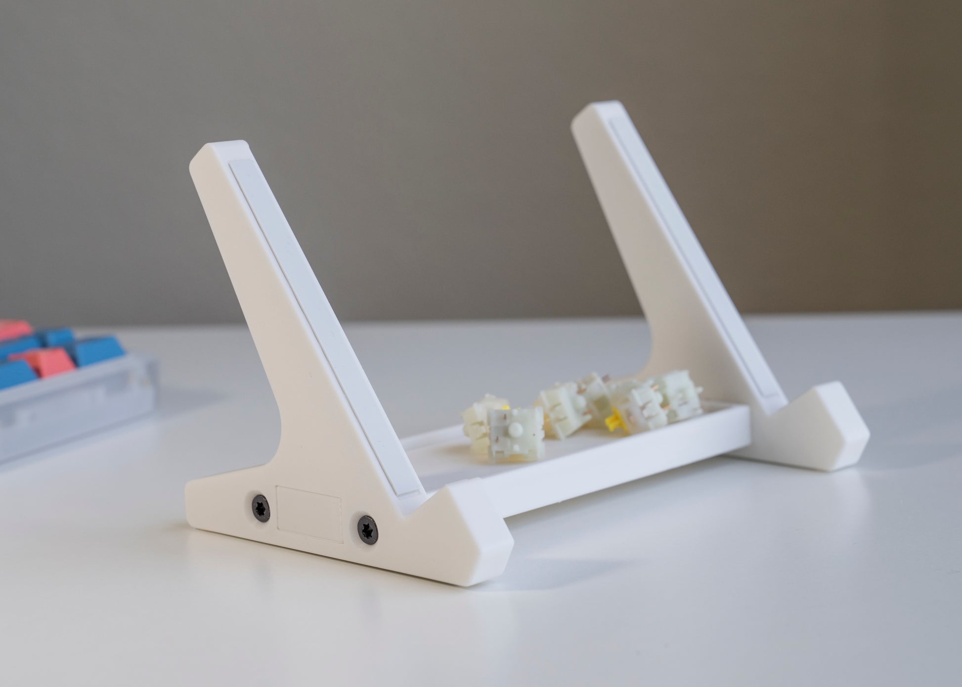 front of of white 3D printed PLA keyboard stand with silicone padding for mechanical keyboards